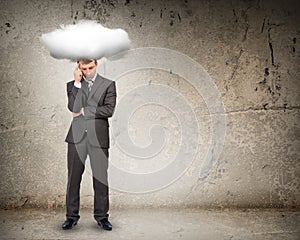 Sad businessman with cloud above head, front view