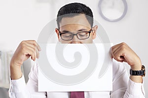 Sad Businessman Shows White Paper, Copyspace