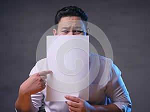 Sad Businessman Shows White Paper, Copyspace