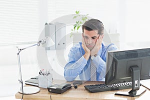 Sad businessman sitting at his desk