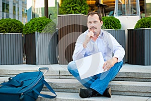 Sad businessman sitting on the steps