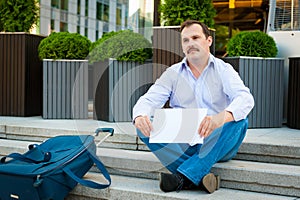 Sad businessman sitting on the steps