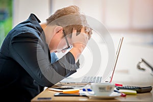 Sad businessman stressed and worried sitting in office. Stress and worry concept. Vintage tone