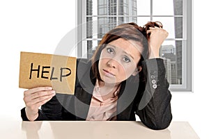 Sad businesswoman in stress at office work asking for help sitting frustrated