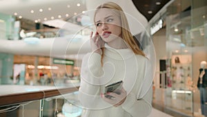 Sad Caucasian anxious female businesswoman 20s woman shopper with smartphone problem bad message on mobile phone despair