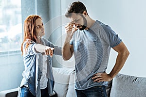 Sad cheerless woman pointing at the door