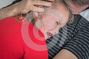 Sad child crying on father`s chest