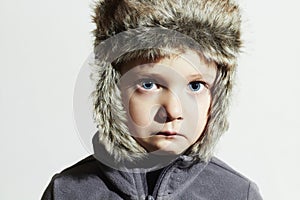 Sad child in fur Hat.Kids casual winter style.little boy.children emotion