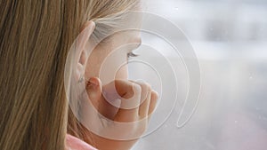 Sad Child Looking on Window, Unhappy Thoughtful Kid, Girl Face, Snowing Winter