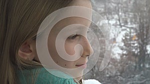 Sad Child Looking on Window, Unhappy Thoughtful Kid, Girl Face, Snowing Winter