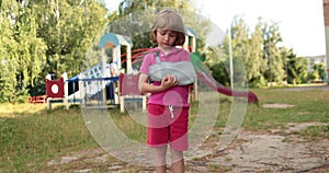 Sad child outdoors with a broken limb small, injured boy.