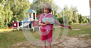 Sad child outdoors with a broken limb small, injured boy.