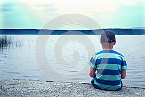 Sad child sitting alone