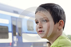 Sad child at train stop