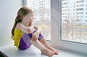 Sad child at the window