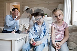 Sad children listen parents have angry fight at home headshot photo