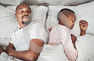 Sad, conflict and black couple in bed after a fight, communication fail and divorce from above. Mental health, angry and