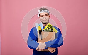 Sad cool guy was fired from work is hugging a box with both hands