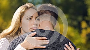 Sad couple embracing, goodbying before parting, military service draft, farewell