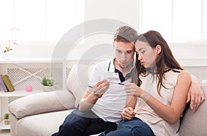 Sad couple after pregnancy test result copy space