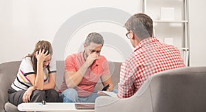 sad couple at psychologist session. family therapy. man and woman talk to social worker.