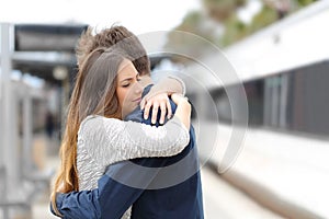 Sad couple saying goodbye before travel photo