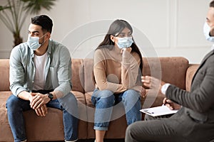 Sad couple sitting at therapy session in therapists office