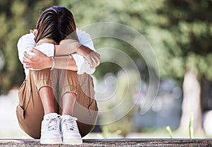 Sad, cry and student with woman in park for depression, frustrated and stress. Mental health, anxiety and fear with