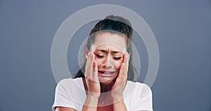 Sad, crying and young woman in a studio with upset, worry and depression face expression. Emotions, grief and female