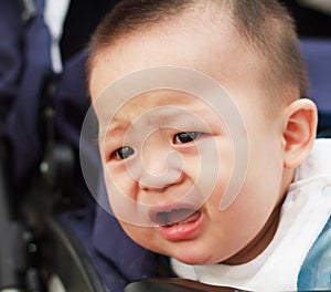 Sad cute asian baby watching out