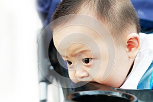 Sad cute asian baby watching out