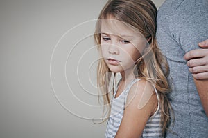 Sad daughter hugging his mother at home.