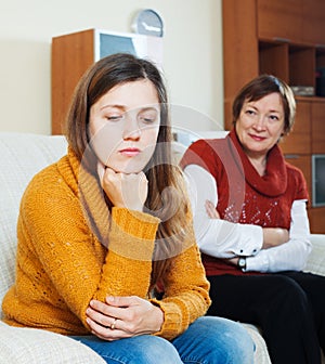 Sad daughter and mature mother having conflict