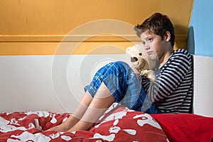 Sad and depressed boy on his bed