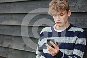 Sad Depressed Boy Male Child Teenager Using Mobile Cell Phone