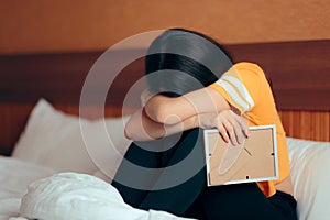 Sad Depressed Girl Crying After Break-up Holding Framed Picture