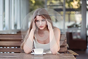 Sad and depressed woman alone in a lonely bar after a break up