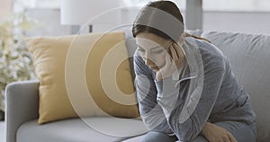 Sad depressed woman self-isolating at home