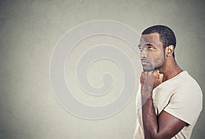 Sad, depressed, worried young man looking up