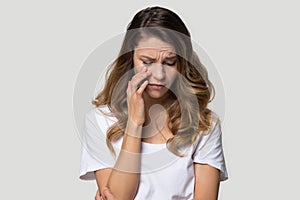 Sad depressed young woman in tears studio headshot