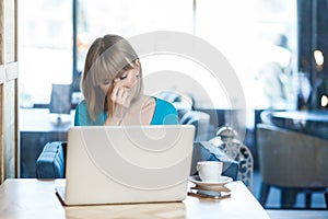 Sad despair woman orking on laptop, crying, hiding her face, having problems with her work.