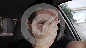 Sad desperate man crying in the car