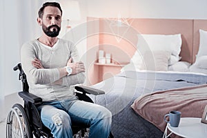 Sad disabled man sitting with his arms crossed