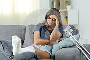 Sad disabled woman complaining alone at home