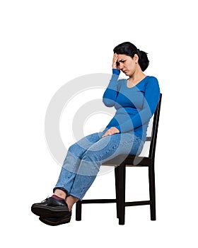 Sad and disappointed woman sitting on a chair covering her face with hand, full length isolated over white background. Desperate