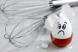 Sad egg with painted face, culinary mistakes