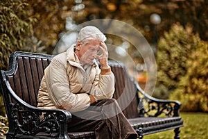 Sad elderly man outdoors