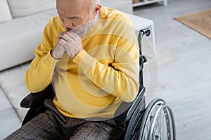 Sad elderly man sitting in wheelchair