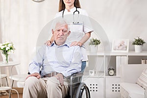 Sad elderly man on wheelchair