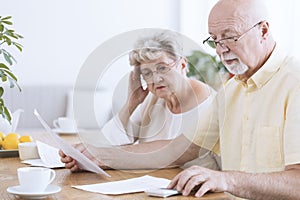 Sad elderly marriage with documents